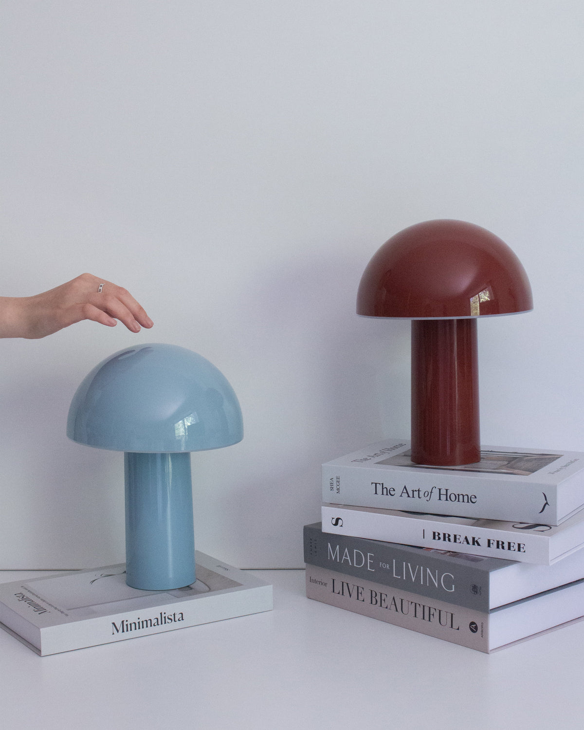 Light blue and red portable lamps with dome shades and cylindrical bases