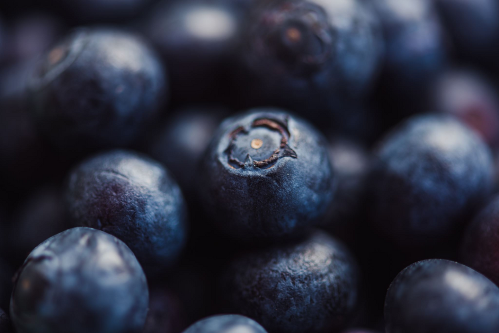 Blueberries background with a focus on whole blueberries.