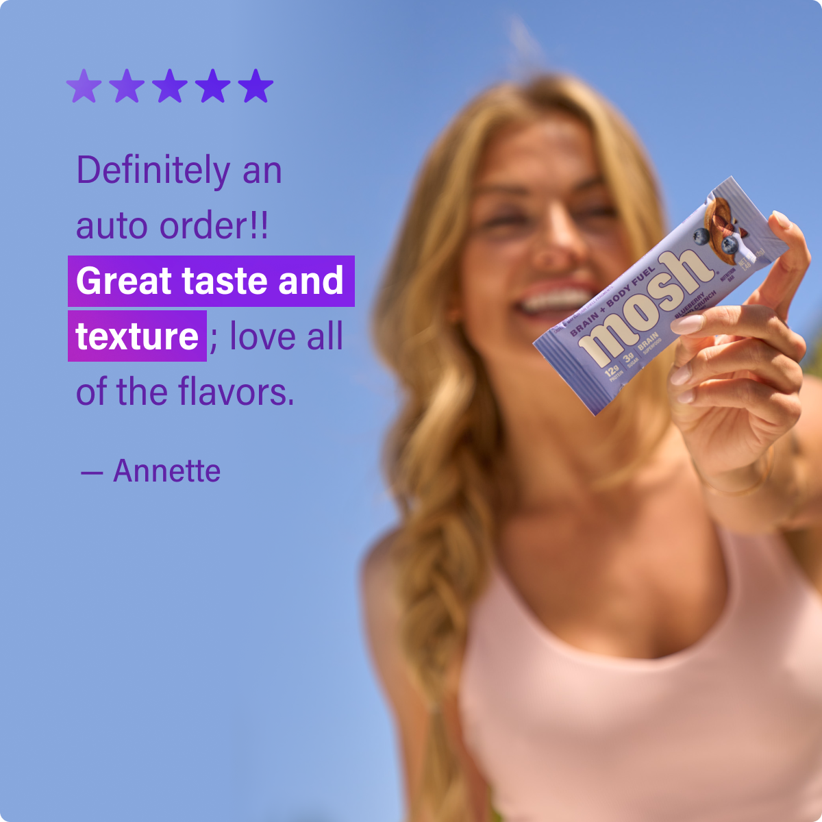 Blueberry Almond Crunch mosh protein bar held up in its foil wrapper
