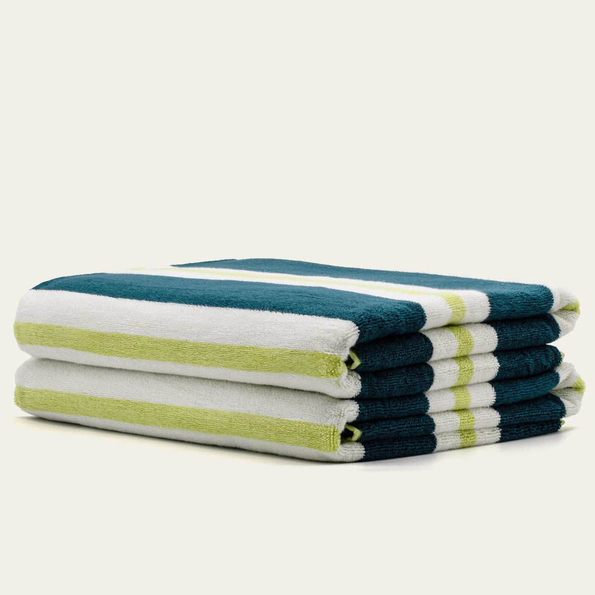 Cotton beach towel stack with teal, white, and pistachio stripes, folded