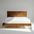 Solid wood bed frame with vertical slat headboard and wide plank footboard