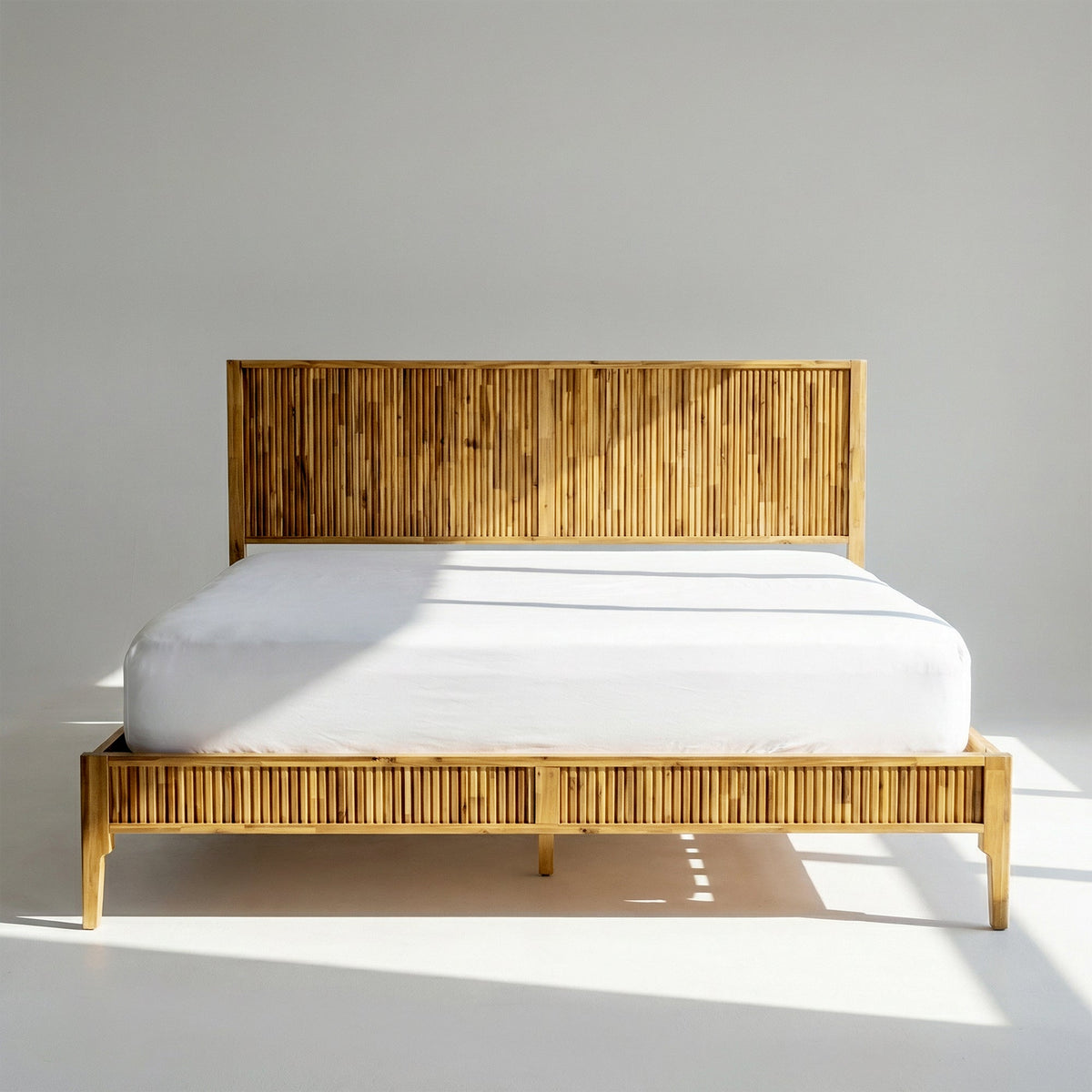 Solid wood bed frame with vertical slat headboard and platform base