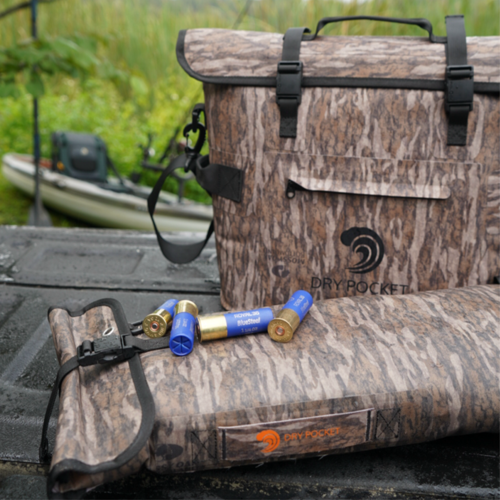 Bottomland camo floating cooler bag with Dry Pocket side pouch on truck bed