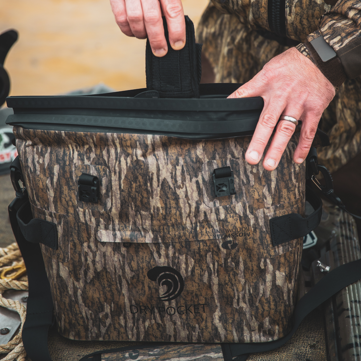 Waterproof floating cooler bag top with black lid, camo body, and carry handle
