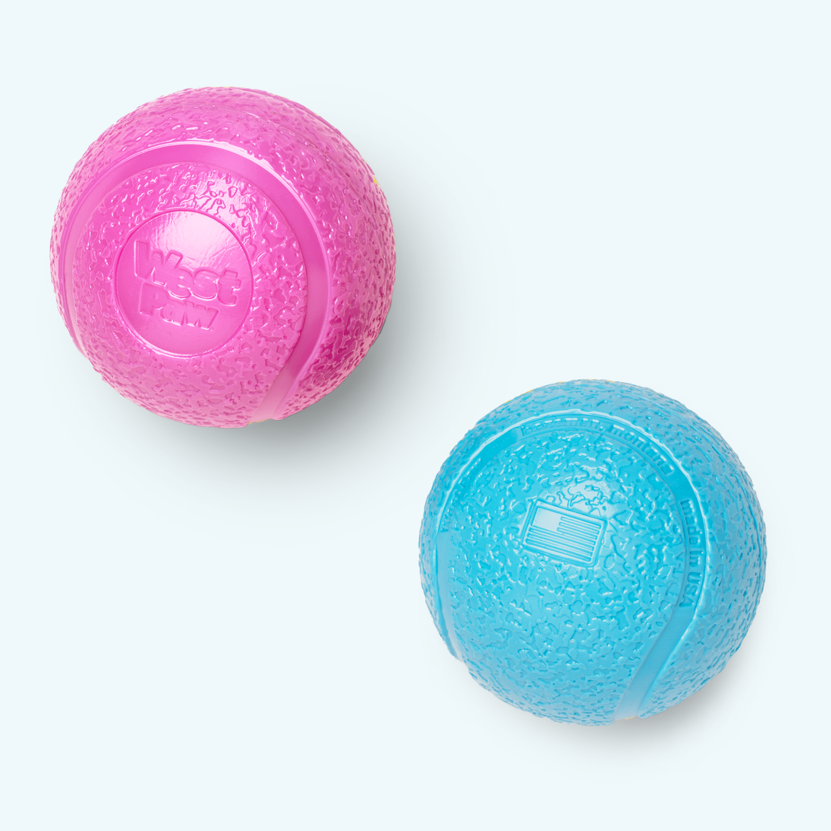 Pink and blue textured dog balls with embossed logos.