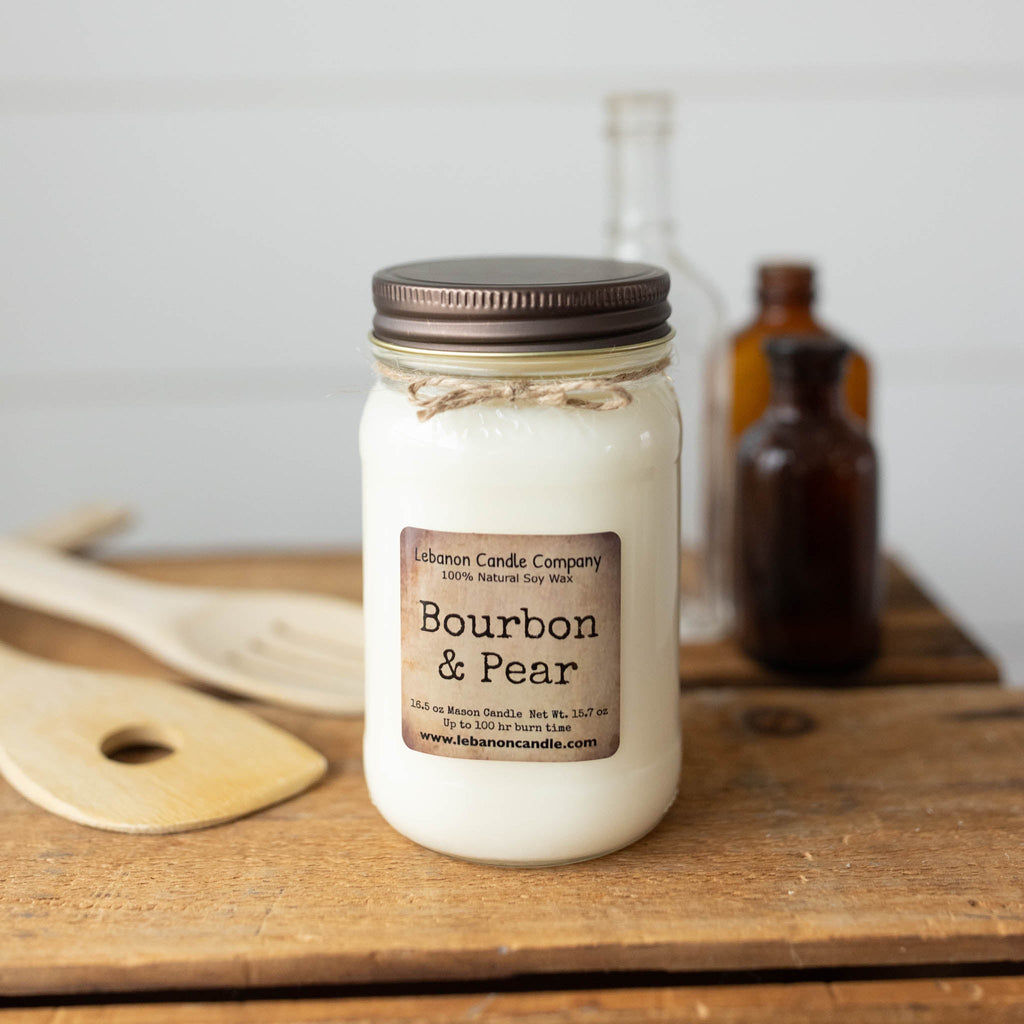 Bourbon & Pear soy wax candle in clear glass jar with black lid and twine wrap