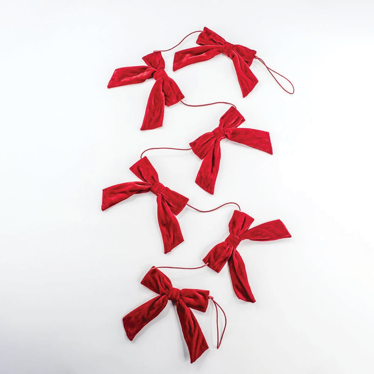 Red velvet bow garland with evenly spaced bows on thin red cords