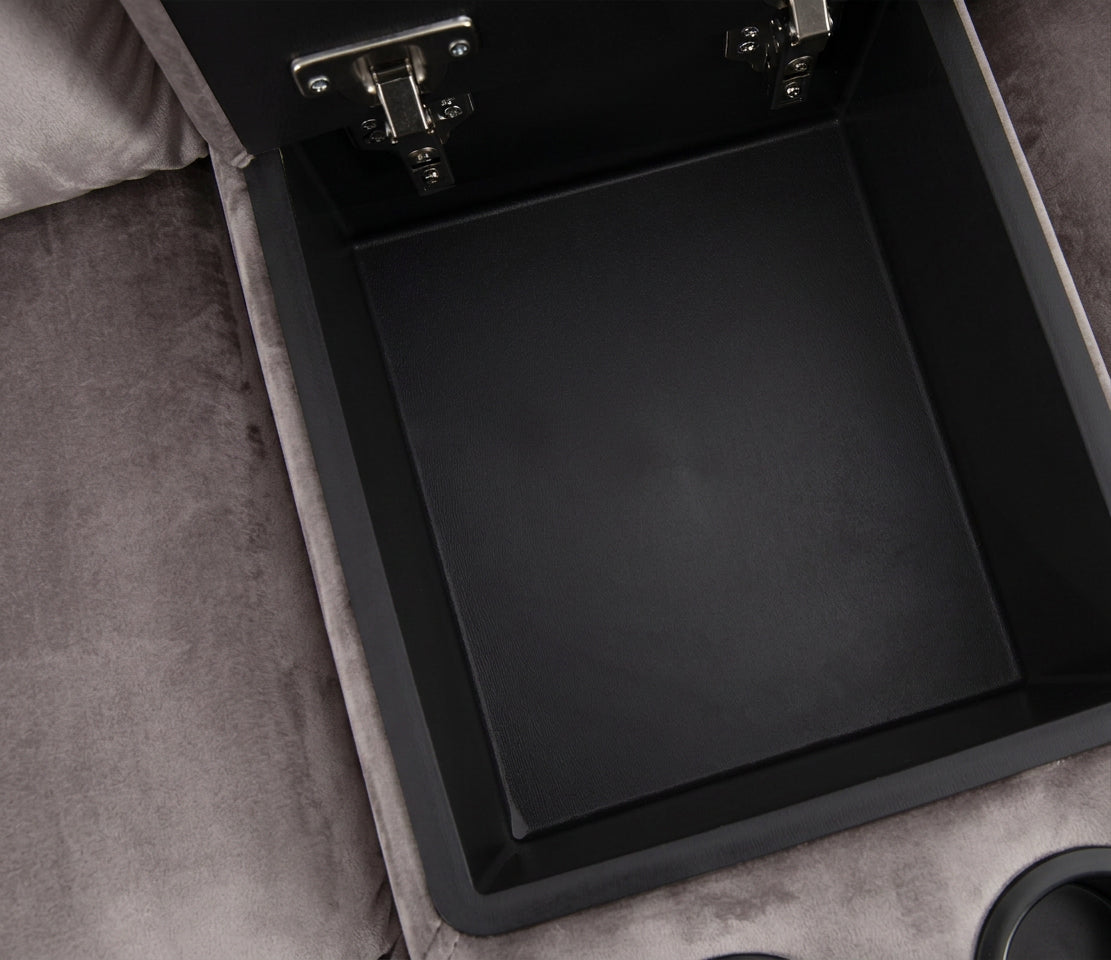 Open storage console tray with black interior on a gray reclining sectional