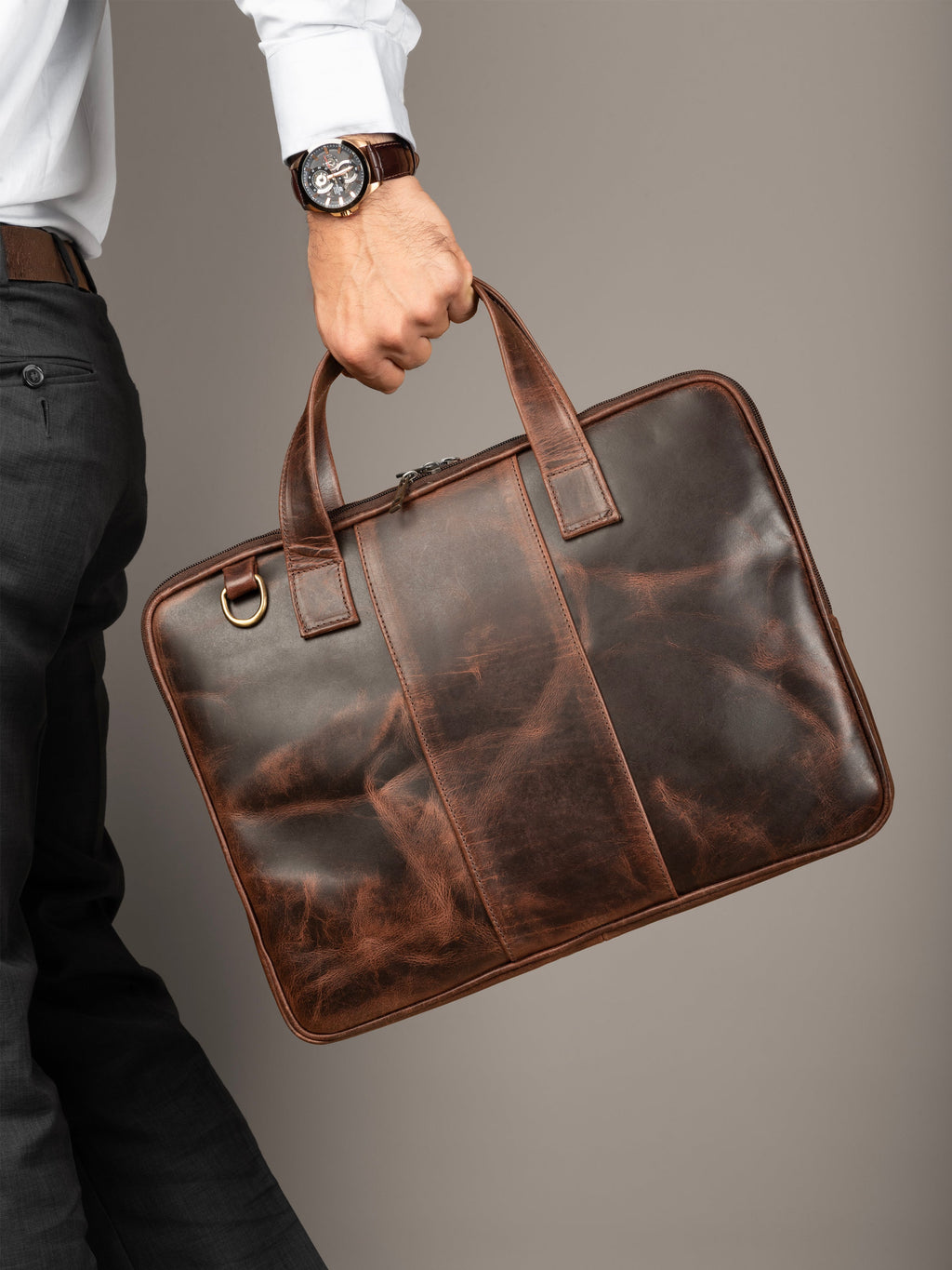 Brown leather laptop briefcase with stitched panel design and top carry handle