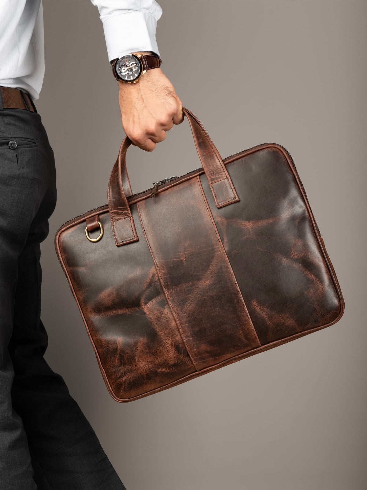 Brown leather laptop briefcase with stitched panel design and top carry handle