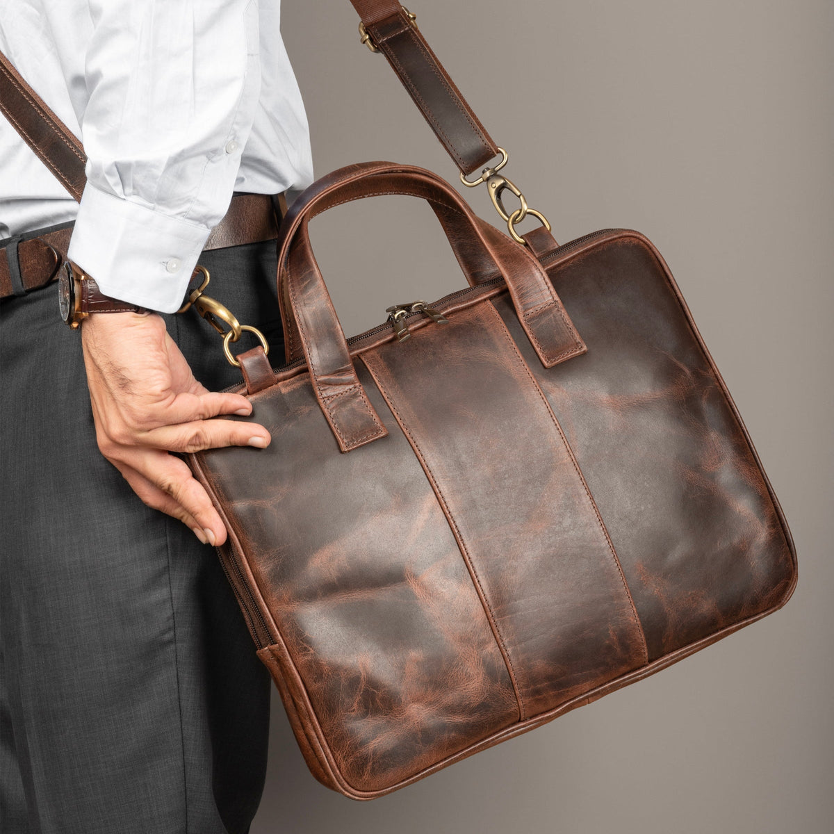 Brown leather laptop briefcase with dual handles and detachable shoulder strap