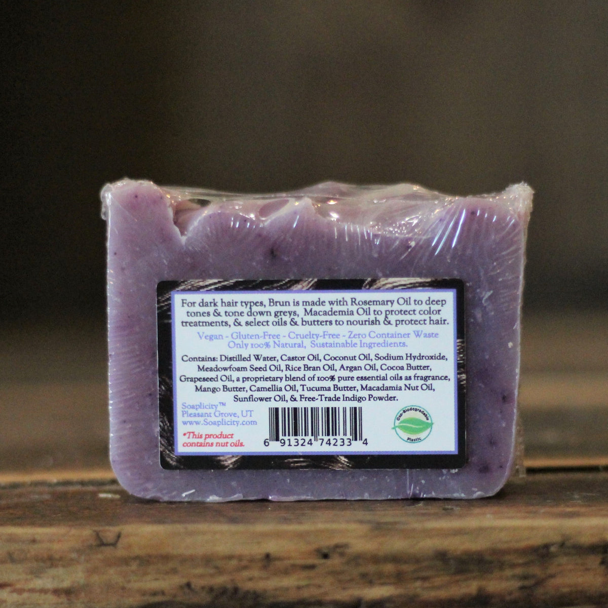 Purple shampoo bar soap with ingredient label on the back side