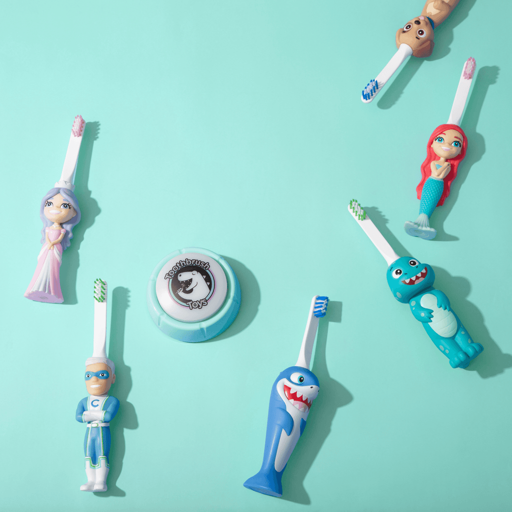 Assorted kids character toy toothbrushes with blue, green, and pink figure handles