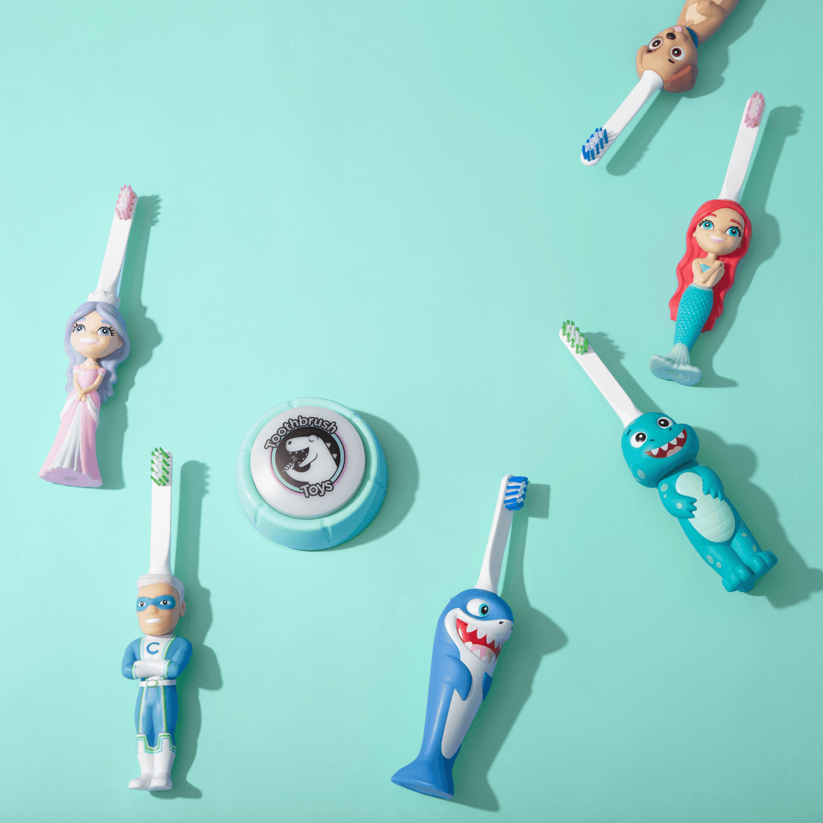 Assorted kids character toy toothbrushes with blue, green, and pink figure handles
