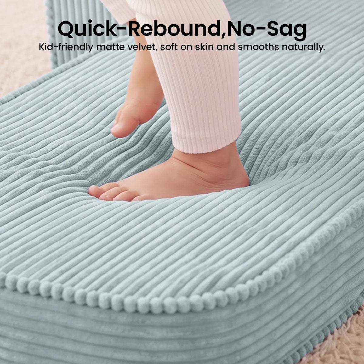 Soft teal corduroy kid sofa with round armrests and pom-padded trim