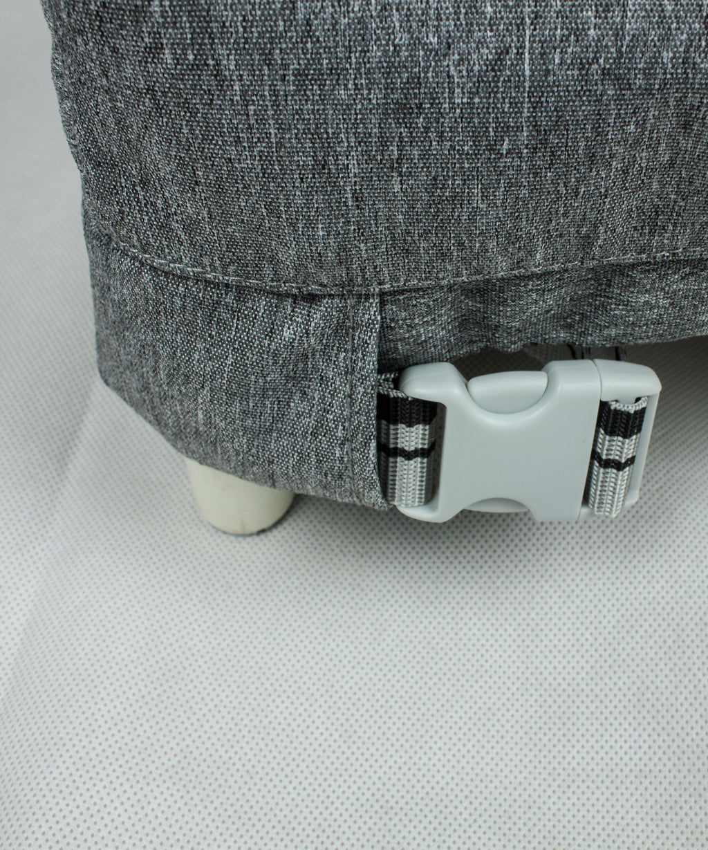 Gray loveseat cover with adjustable buckle strap near bottom edge