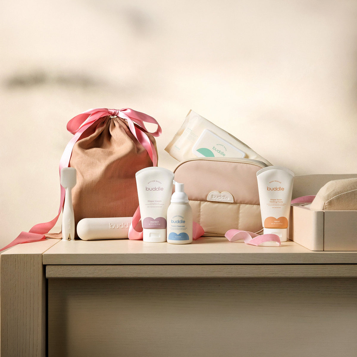 Diaper rash kit with drawstring pouch and buddle skincare bottles on a shelf