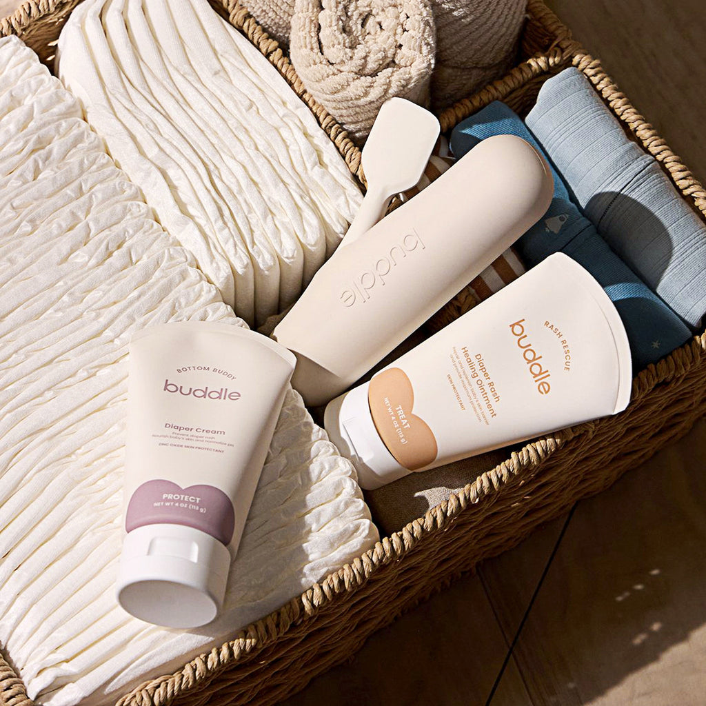 Diaper rash kit products in a tray: buddle bottles, tubes, and wipes packs