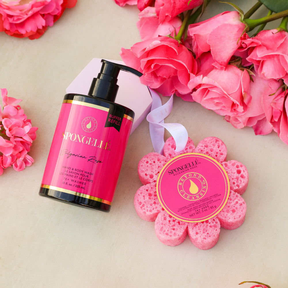 Pink body wash refill bottle with black pump and pink flower sponge refill with ribbon