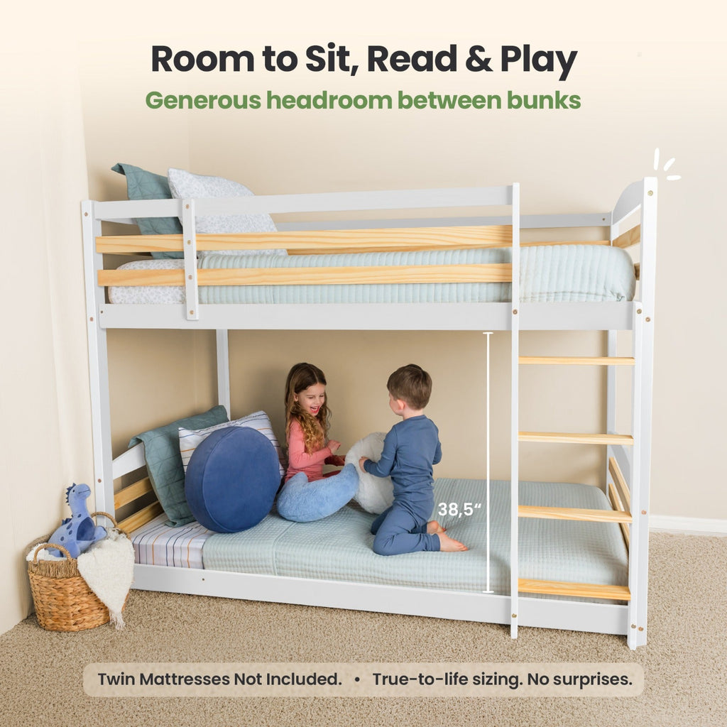 White twin over twin bunk bed with ladder and open space between bunks