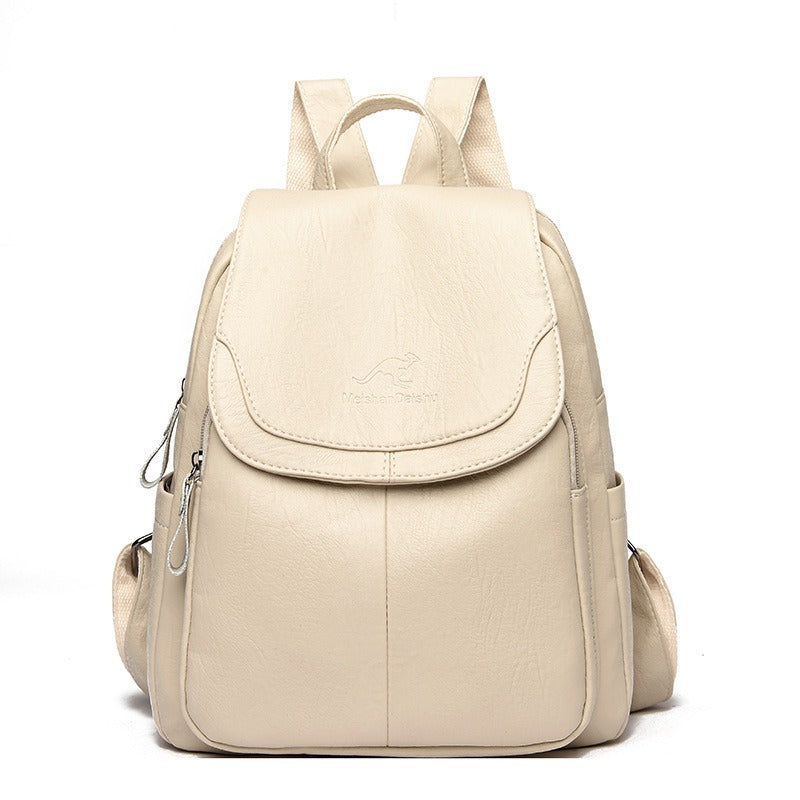 Women’s off-white backpack with front flap pocket, top handle, and side zipper details