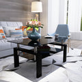 Rectangular black glass coffee table with clear glass top and modern legs