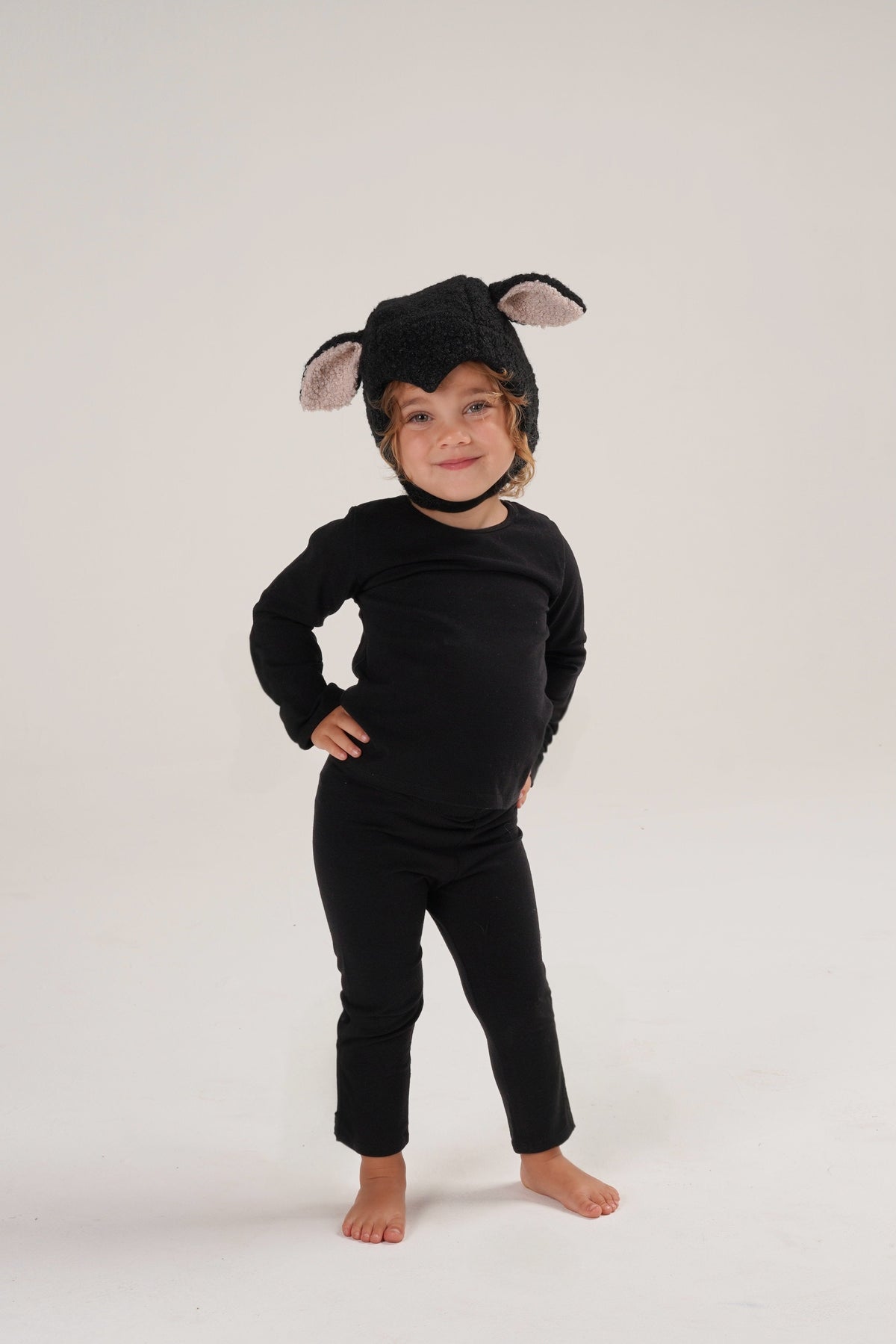 Full-body black sheep costume with hood and plush ear details, baby size