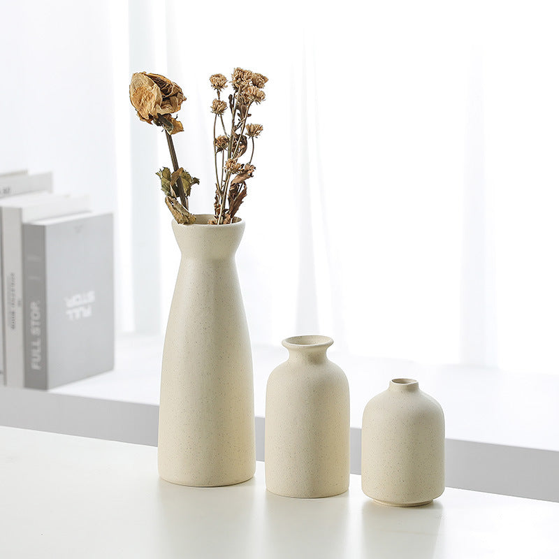 Beige ceramic vase decoration set of 3 narrow bottles, one filled with dried flowers
