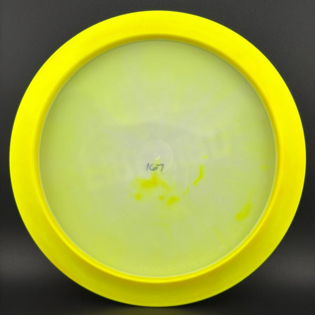 Disc golf driver underside in neon chartreuse with faint stamped markings