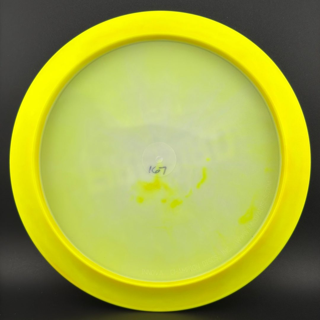 Disc golf driver underside in neon chartreuse with faint stamped markings
