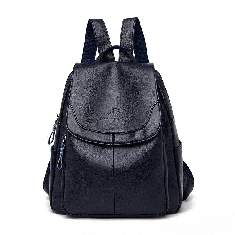 Women’s black backpack with front flap pocket, top handle, and side zipper details
