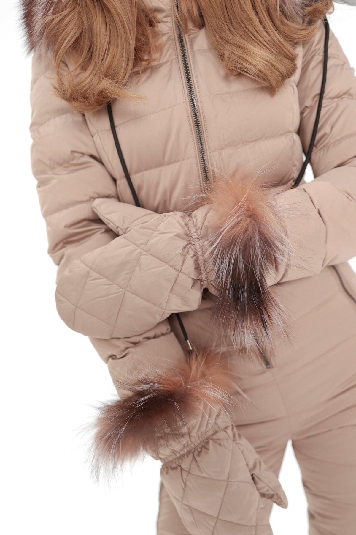Beige down-insulated snow suit with faux fur cuffs and zipper front, close-up