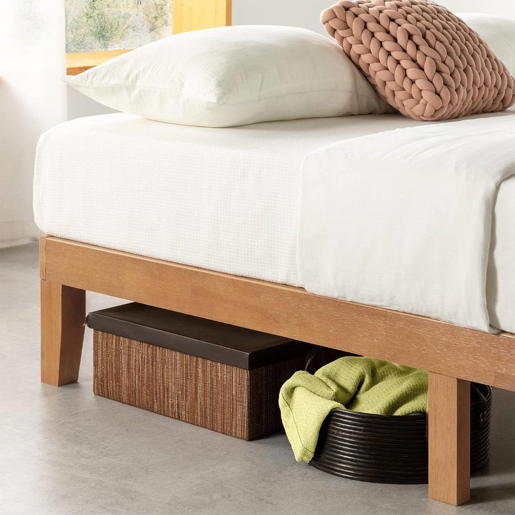 Close view of the natural wood bed frame's side rail and legs