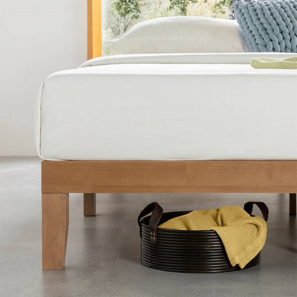 Close view of the bed frame's wooden side rail and tapered leg