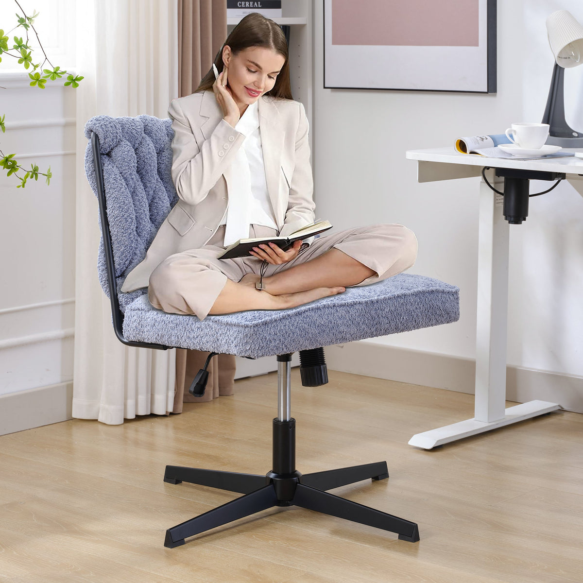 Blue armless desk chair with tufted back, padded seat, and black star base