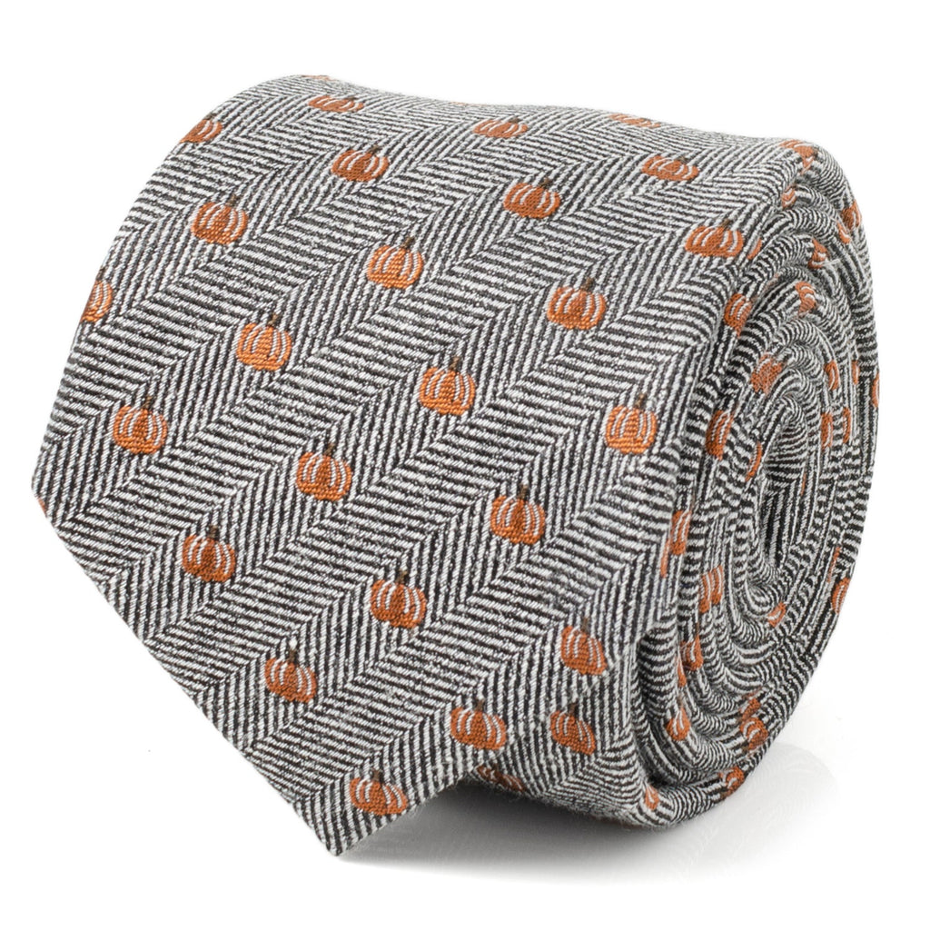 Gray herringbone necktie with orange pumpkin pattern, narrow width and folded design.