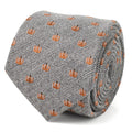 Gray herringbone necktie with orange pumpkin pattern, narrow width and folded design.
