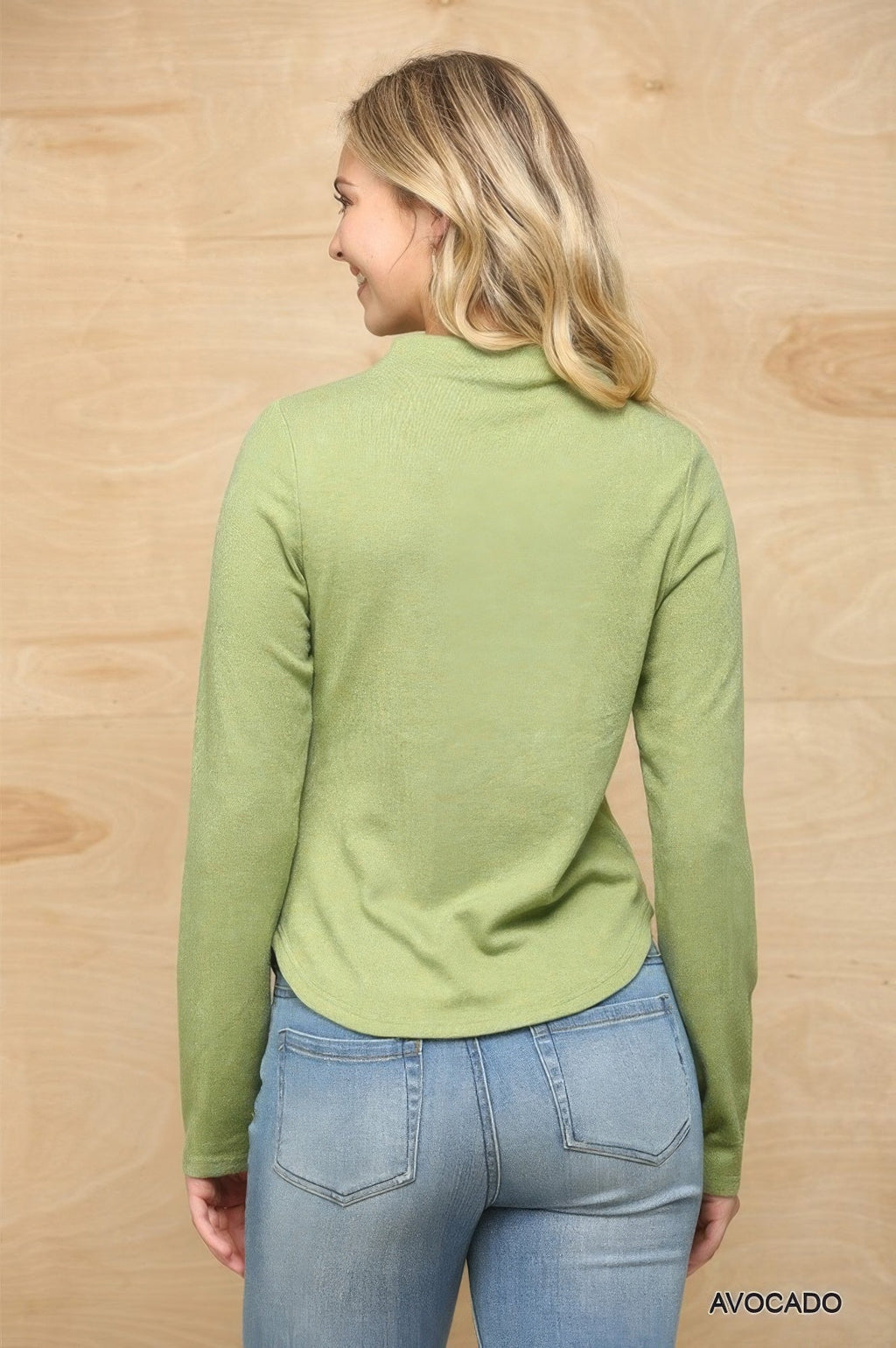 Avocado green knit mock neck top with ruched side detail, seen from back