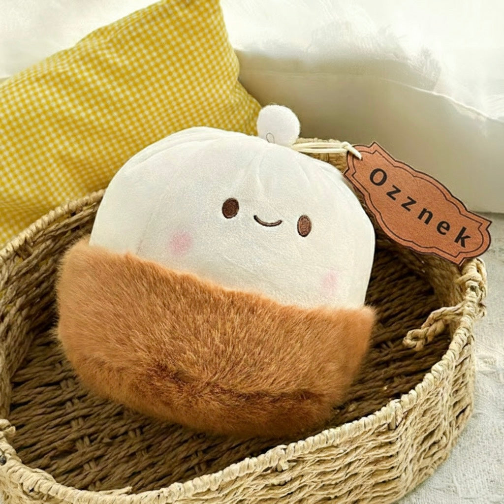 Soup dumpling plush toy close-up, white face with blush dots and brown base