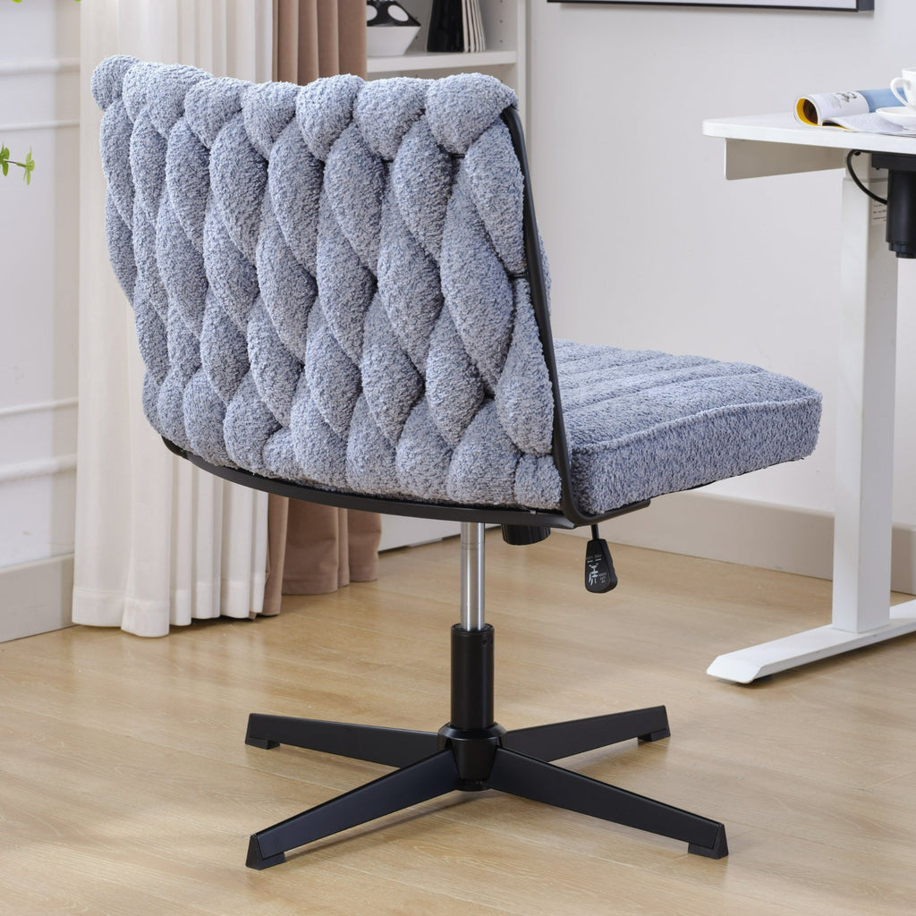 Blue armless office desk chair with tufted boucle upholstery and black star base, no wheels.