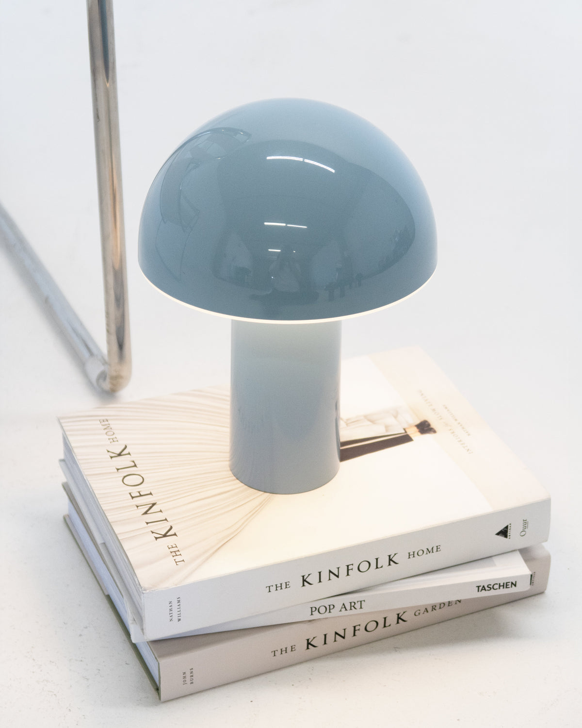 Light blue portable lamp with domed top and cylindrical base