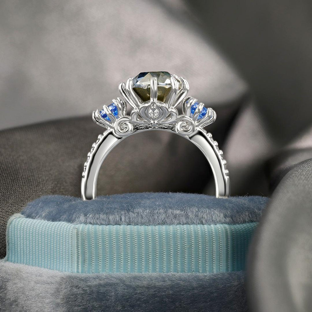 Silver-tone gemstone ring with green square-cut center and blue side accents