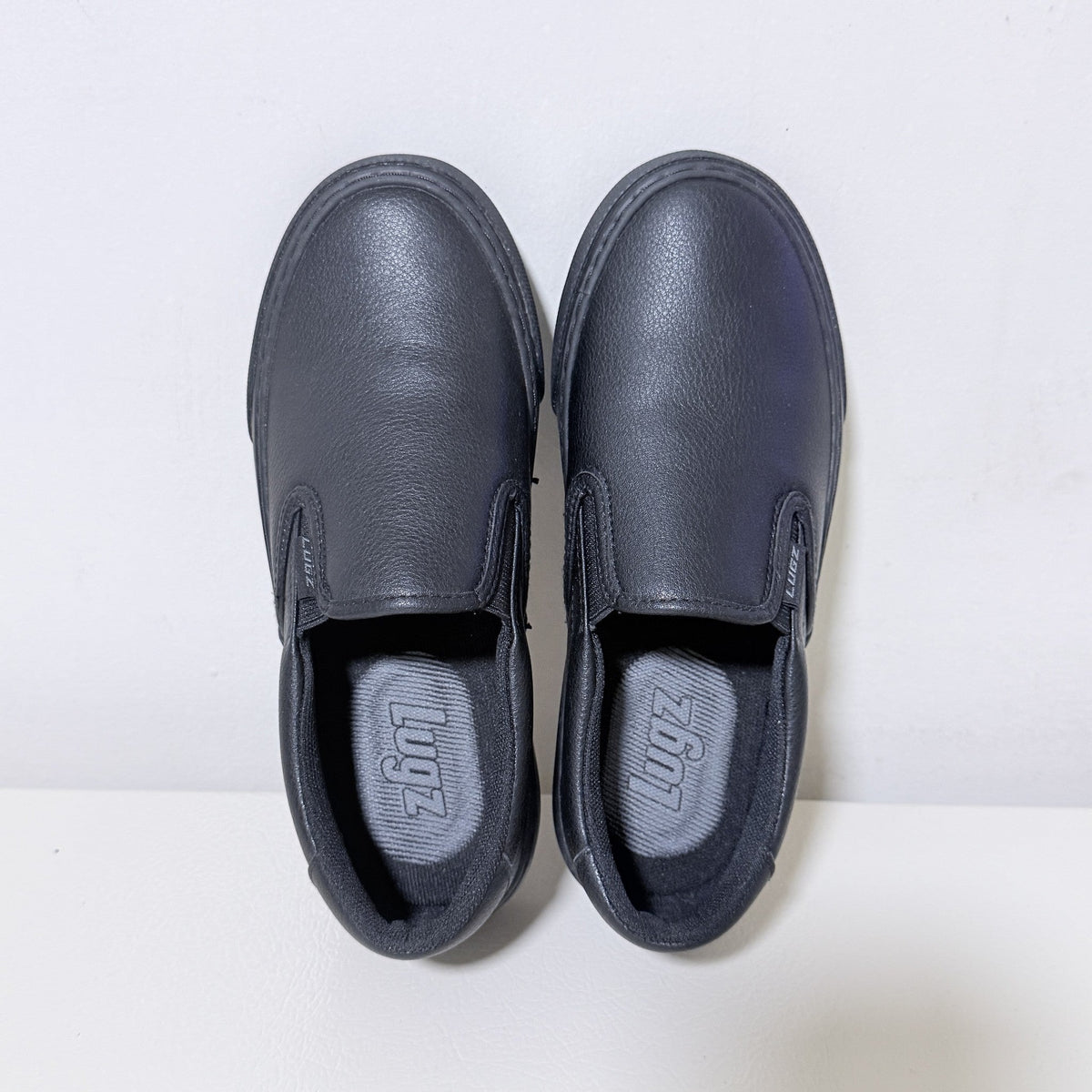 Black slip-on work shoes, front view with dual pull-on tabs