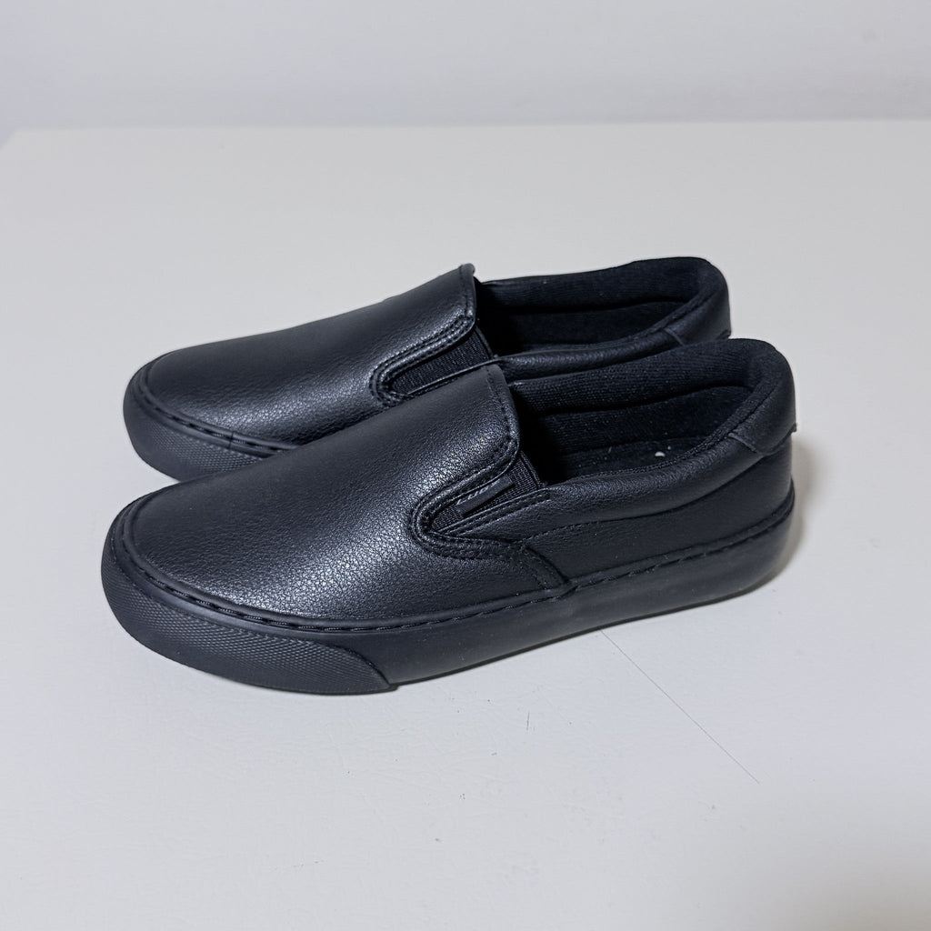 Black slip-on work shoes, side profile with stitched moc-style upper