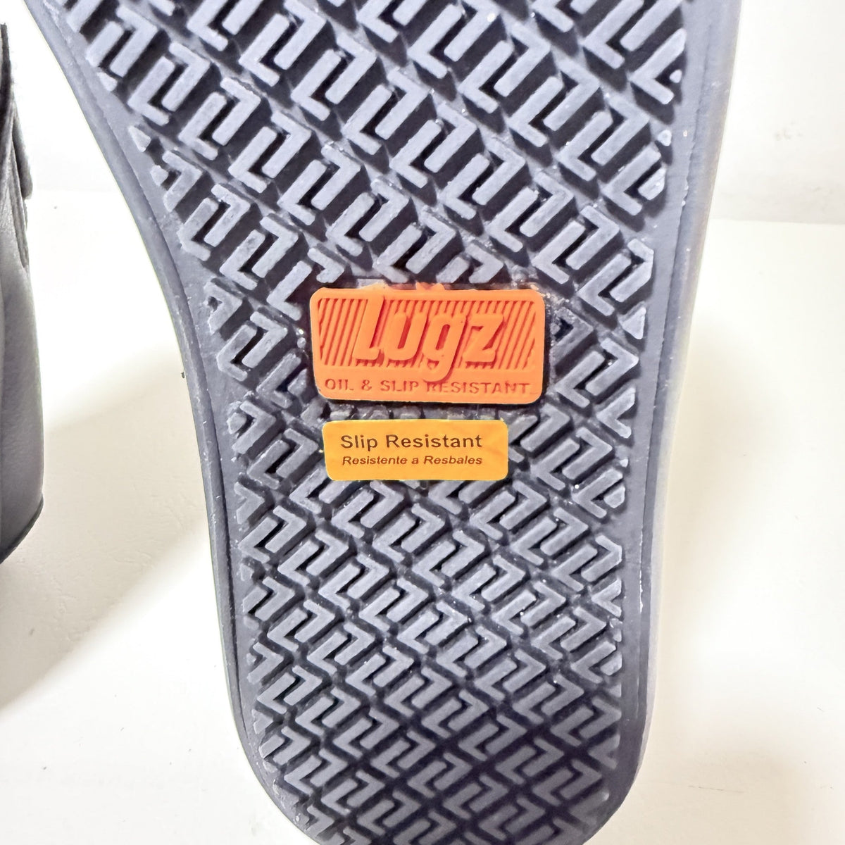 Textured slip-resistant tread with orange Lugz badge and grid pattern