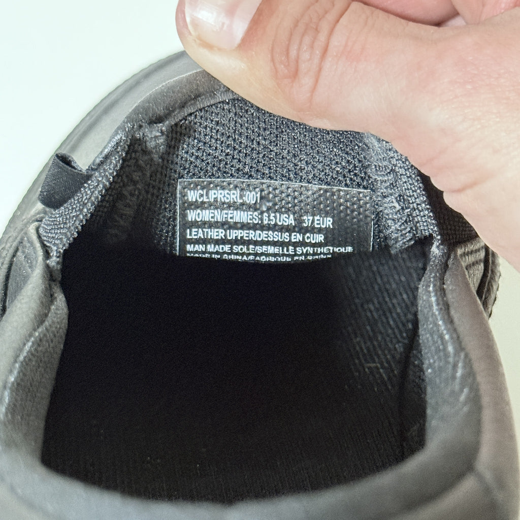 Black slip-on work shoe inner lining with size/size label visible