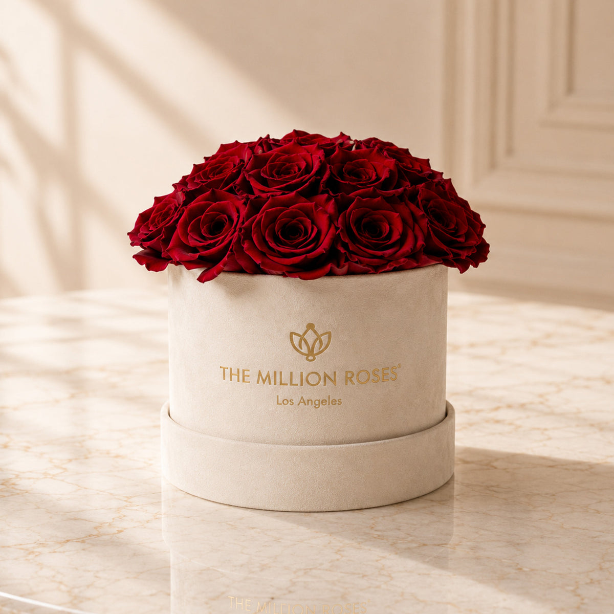 Beige dome box with red roses and gold logo, front view