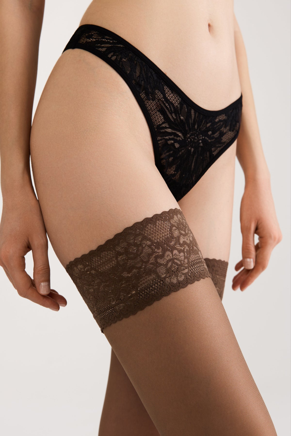 Black sheer thigh-high stockings with floral lace silicone top band