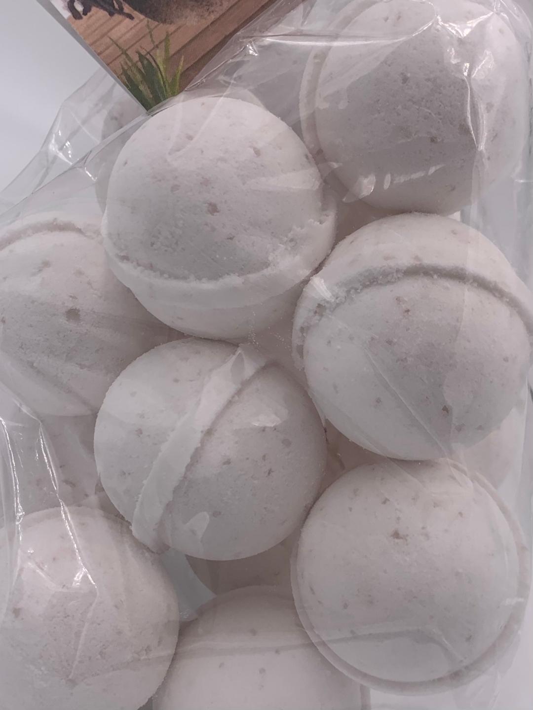 Set of white bath bombs in clear plastic bag, visible round shapes