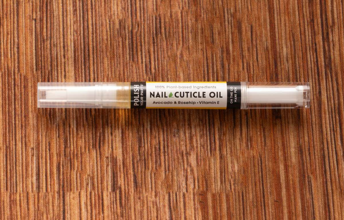 Nail and cuticle oil tube with slim applicator and pale label